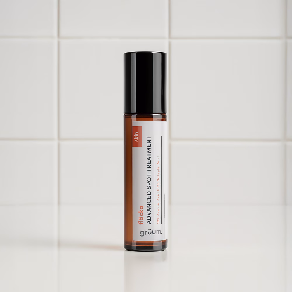 Spot treatment bottle on tiled background.