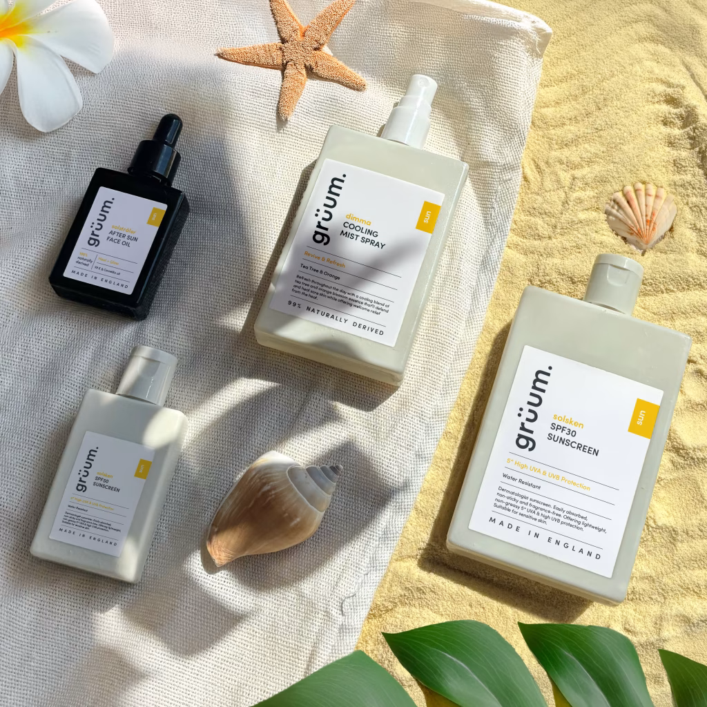 Sunscreen and summer products on a towel.