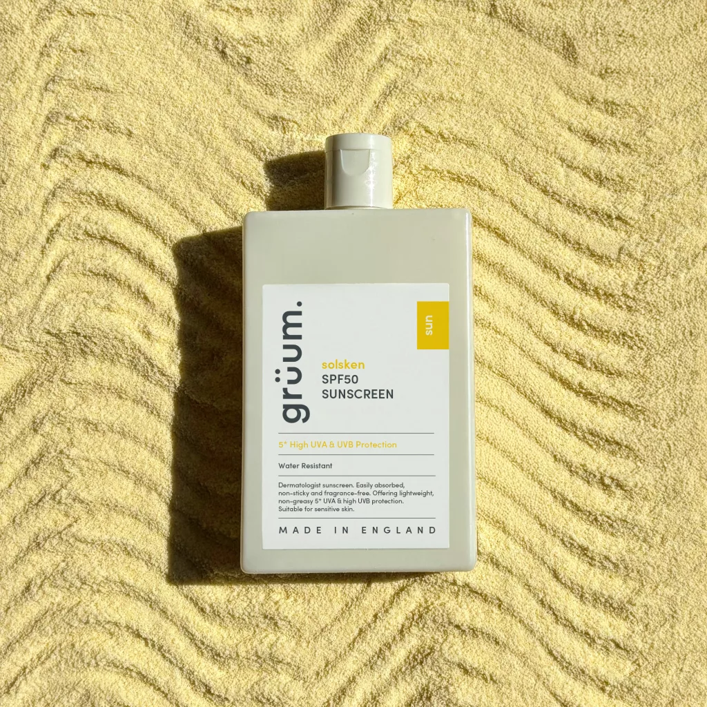 Sunscreen bottle on textured surface.