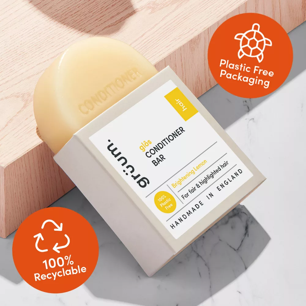 Plastic-free conditioner bar on wooden surface.