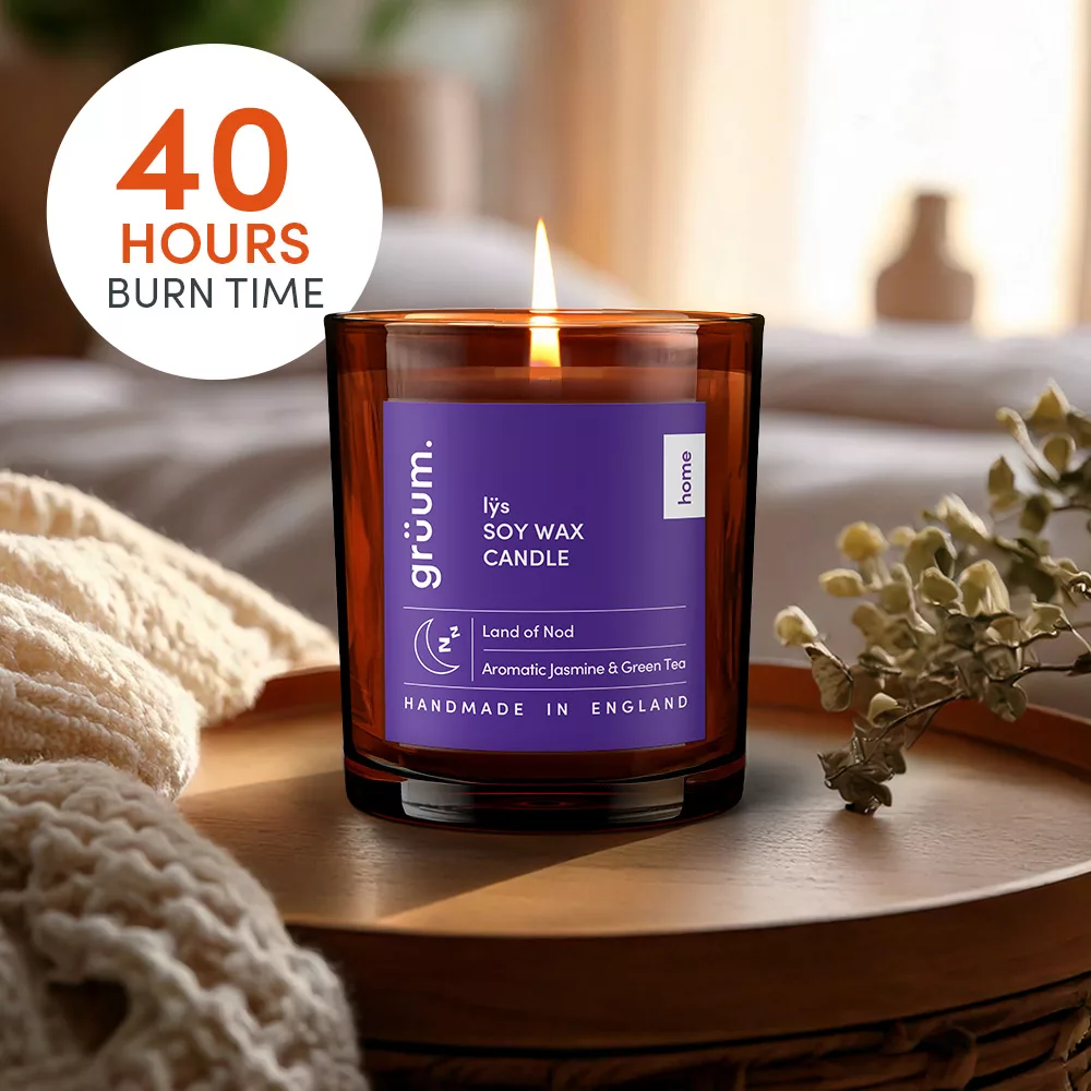 Soy wax candle near flowers.