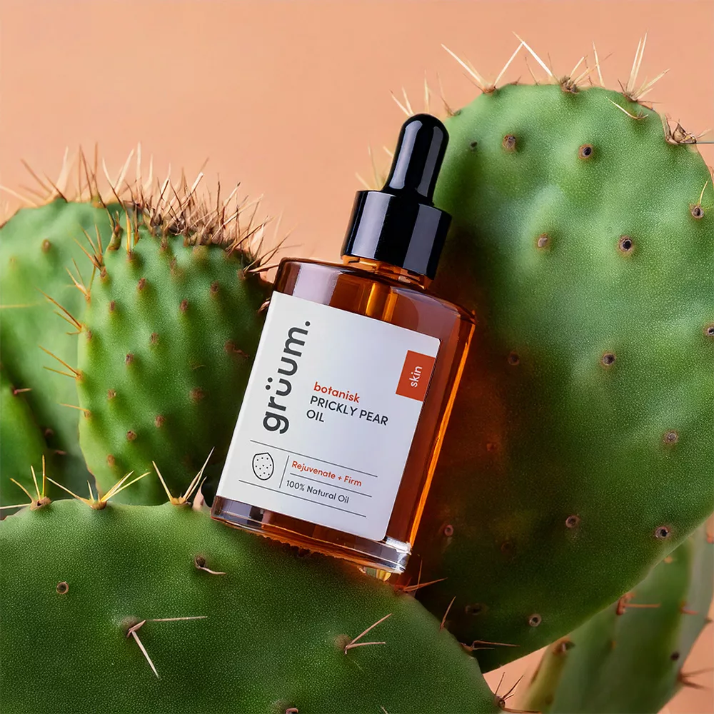 Prickly pear oil bottle on cactus.