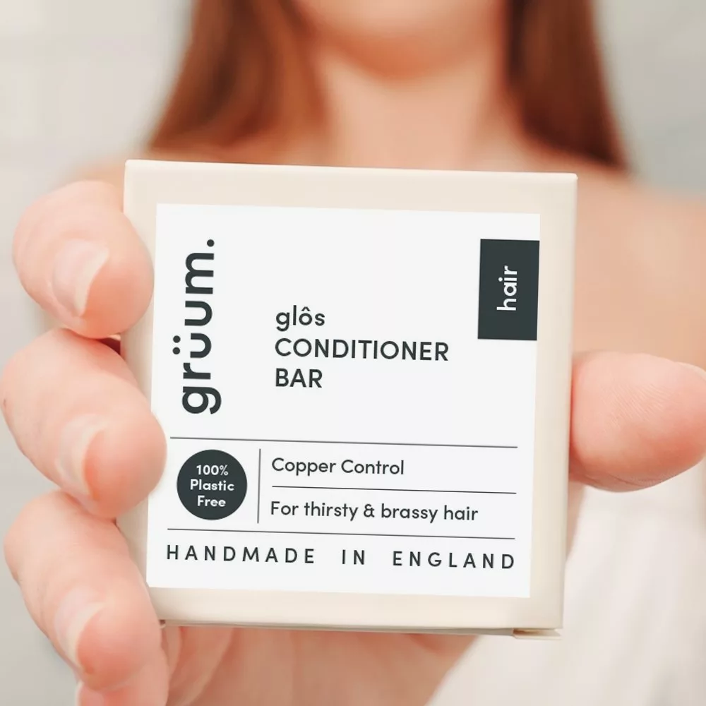 Hand holding conditioner bar package