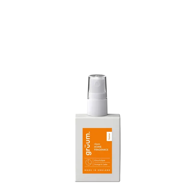Orange fragrance bottle with spray nozzle.