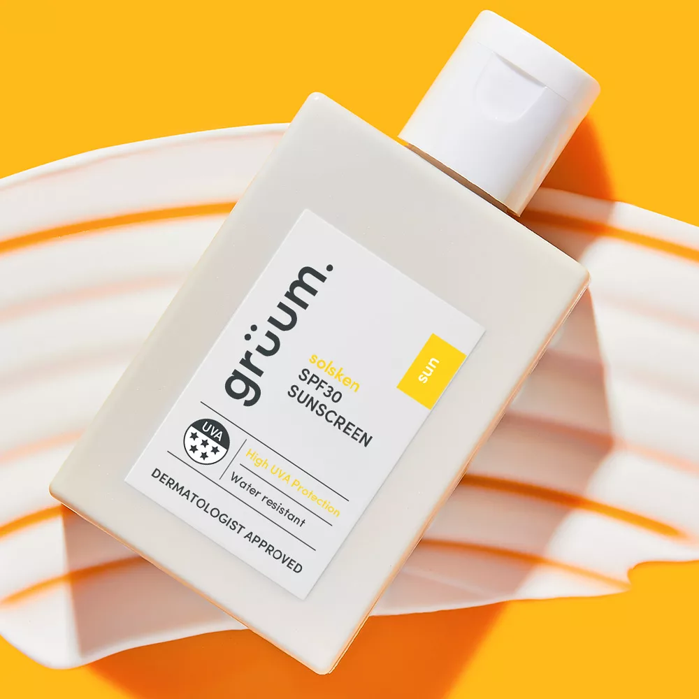 SPF30 sunscreen bottle on striped background