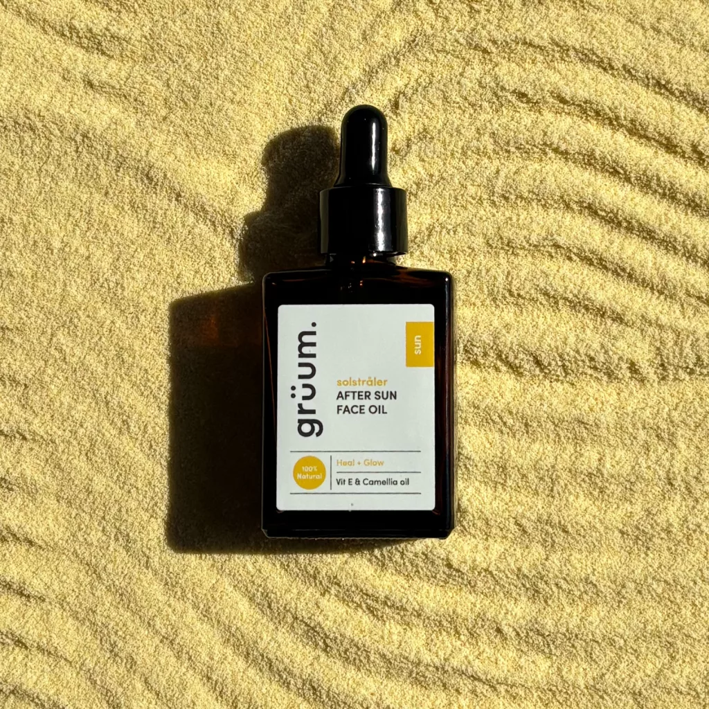 Face oil on textured yellow surface.